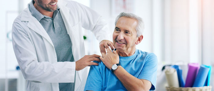 doctor with his hand on patients shoulder